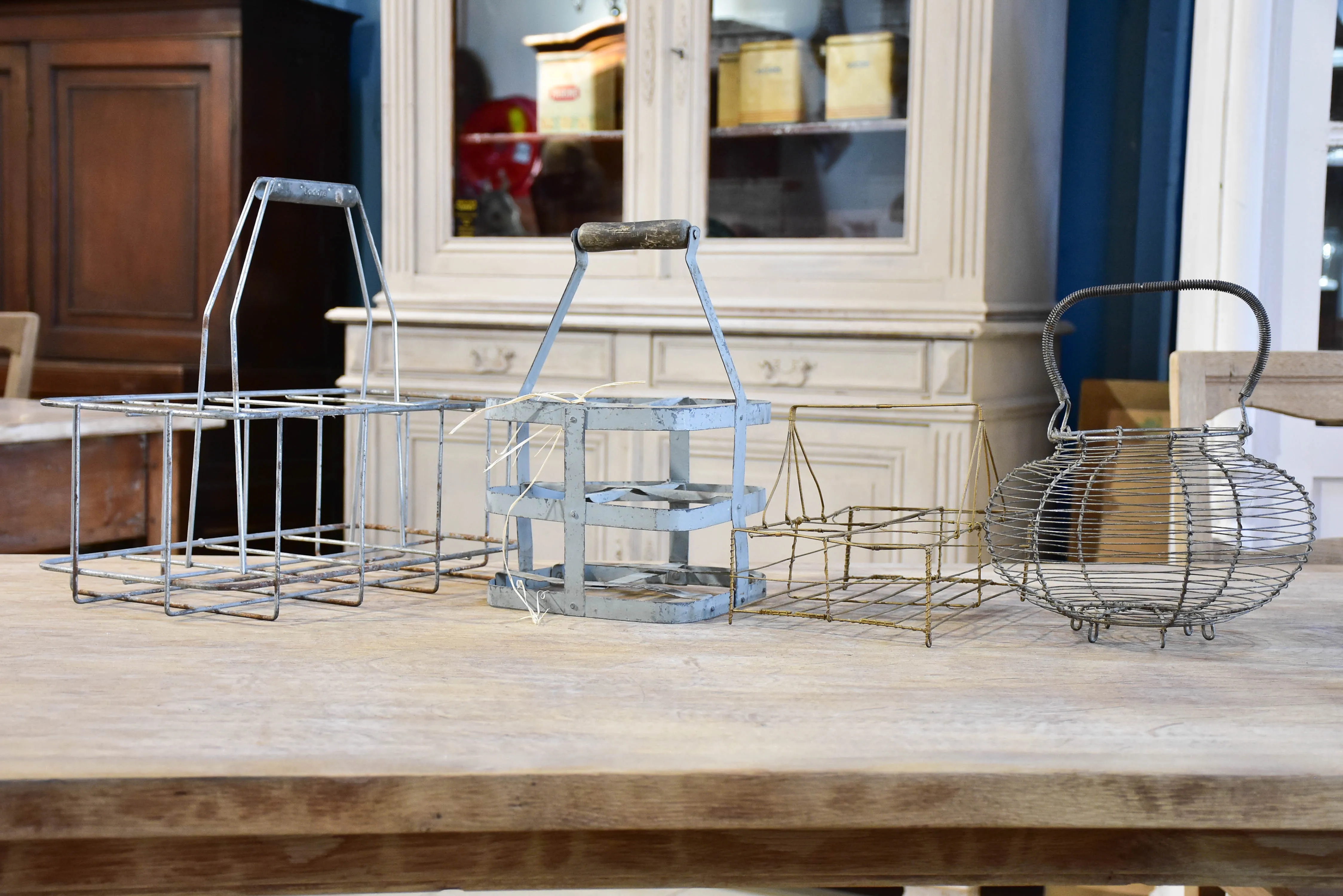 Collection of antique and vintage wire baskets and bottle carriers